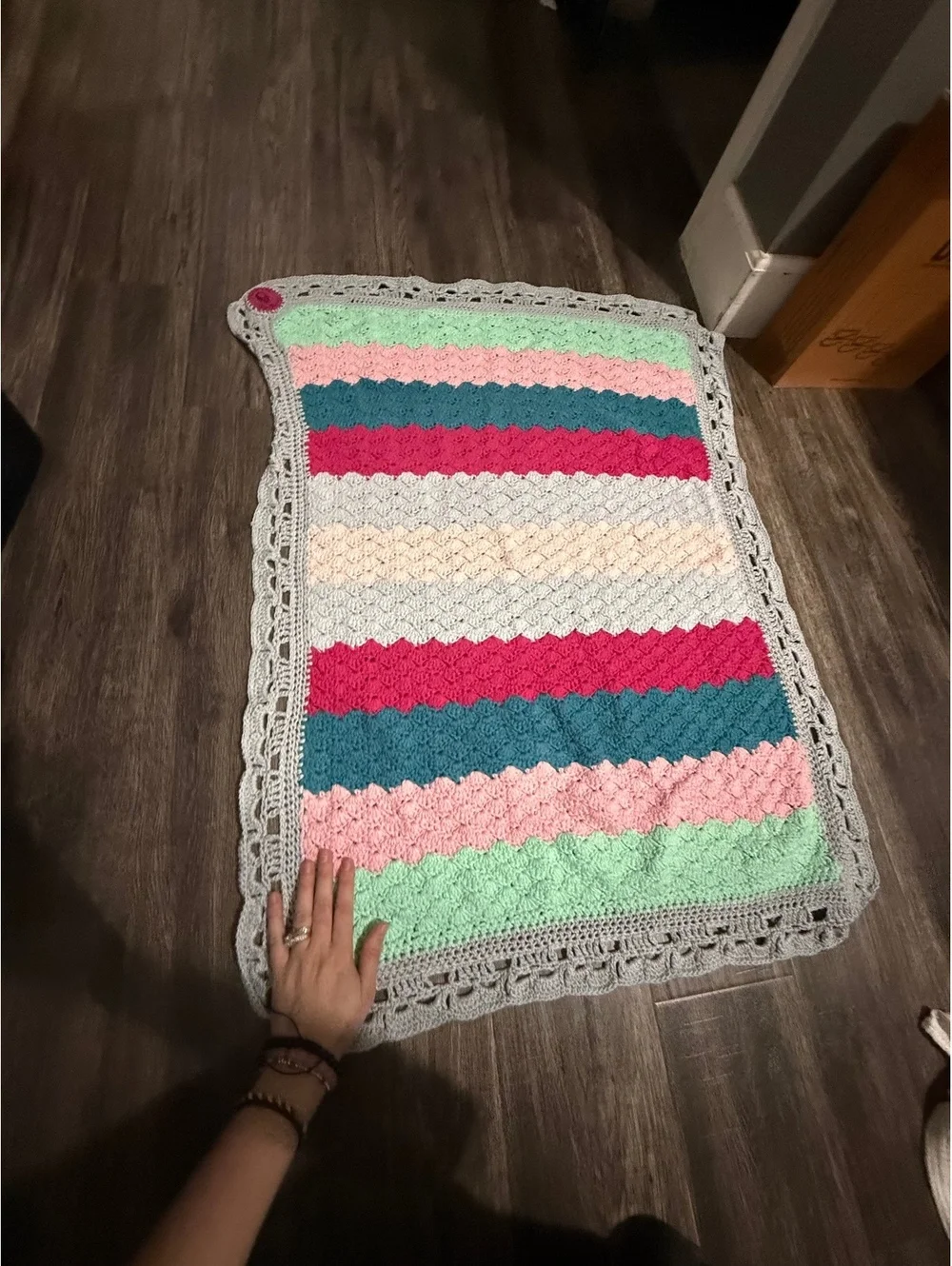 Handmade baby blanket signed by crafter with logo